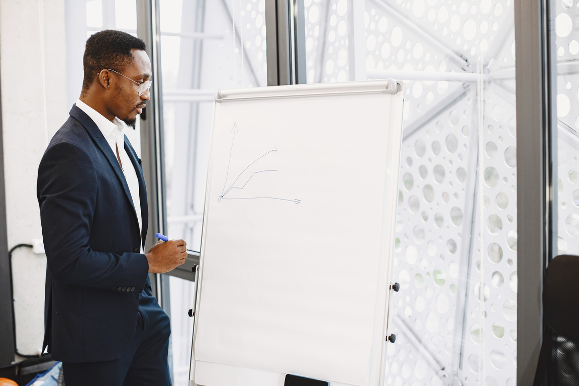 Businessman Drawing on a Flip Chart 
